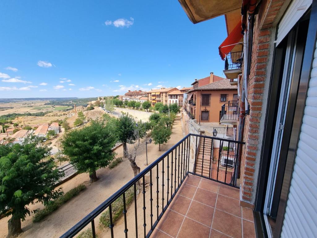 a balcony with a view of a street and trees at El Carmen in Toro