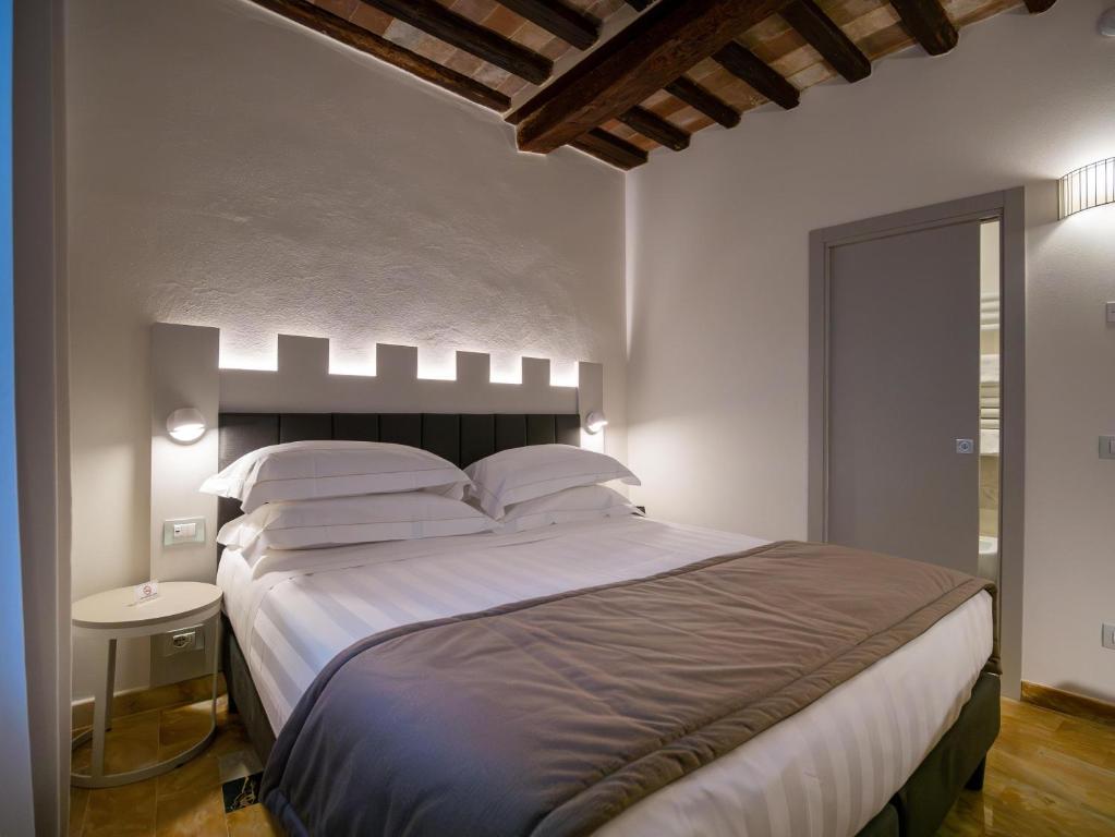 Postel nebo postele na pokoji v ubytování Torre del Fuggisole