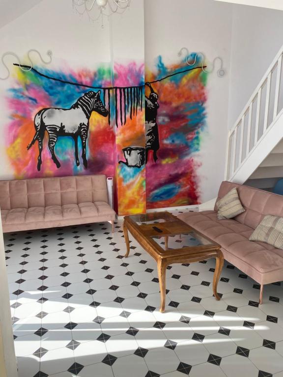 a living room with a zebra painting on the wall at Mechechill in Mechelinki