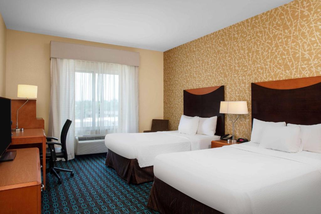 a hotel room with two beds and a desk at Fairfield by Marriott Inn and Suites Augusta Fort Eisenhower Area in Augusta