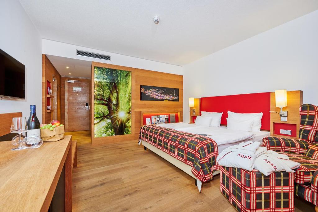 Postel nebo postele na pokoji v ubytování Asam Hotel