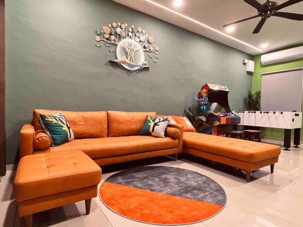 a living room with a couch and a table at Rusa Cottage (Sleeps 10 pax - 1 min walk from KSL) in Johor Bahru