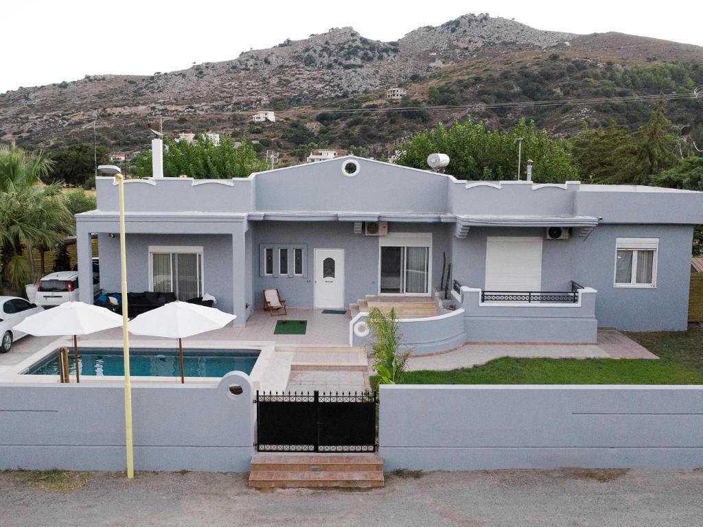 a house with a swimming pool in front of it at MG luxury villa kalithies in Kalithies