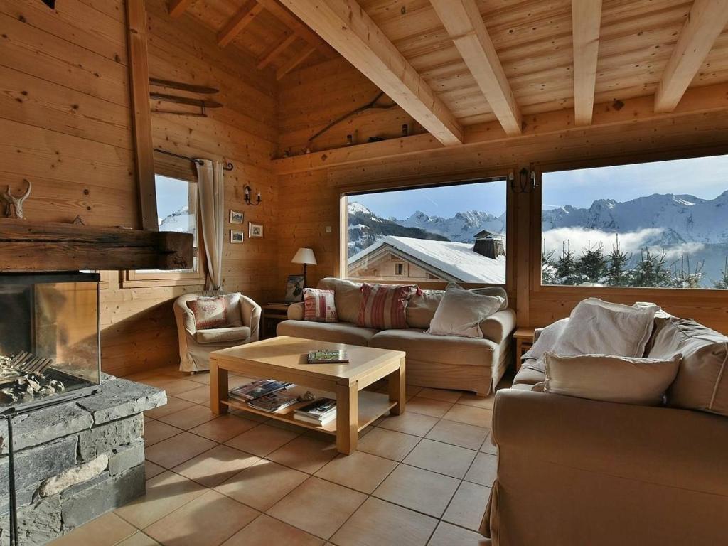 a living room with a fireplace in a cabin at Chalet Le Grand-Bornand, 7 pièces, 10 personnes - FR-1-391-19 in Le Grand-Bornand