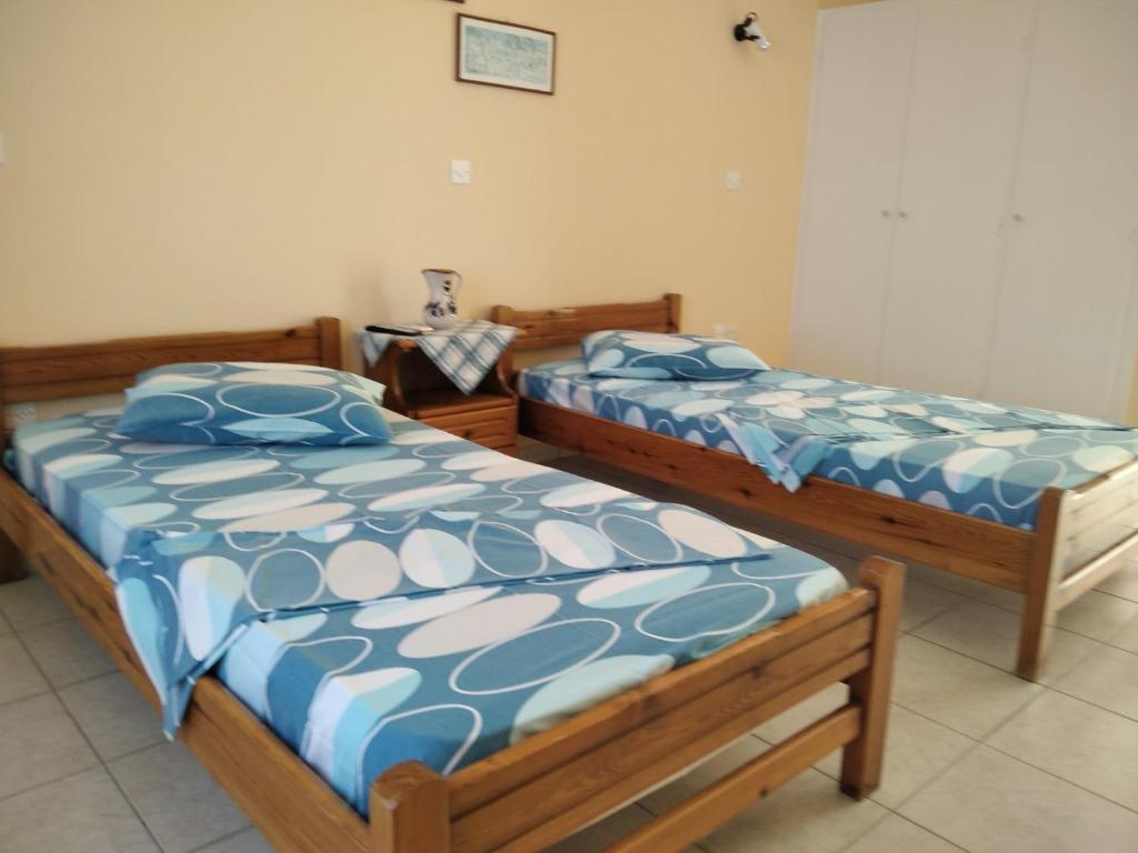 two beds sitting next to each other in a room at Vasila seaview in Tavari