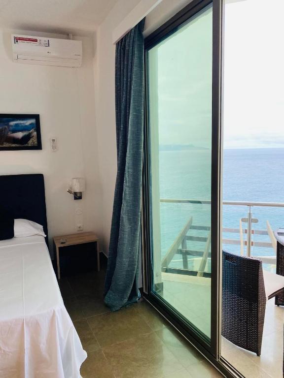 Postel nebo postele na pokoji v ubytování Fogo Boutique Hotel