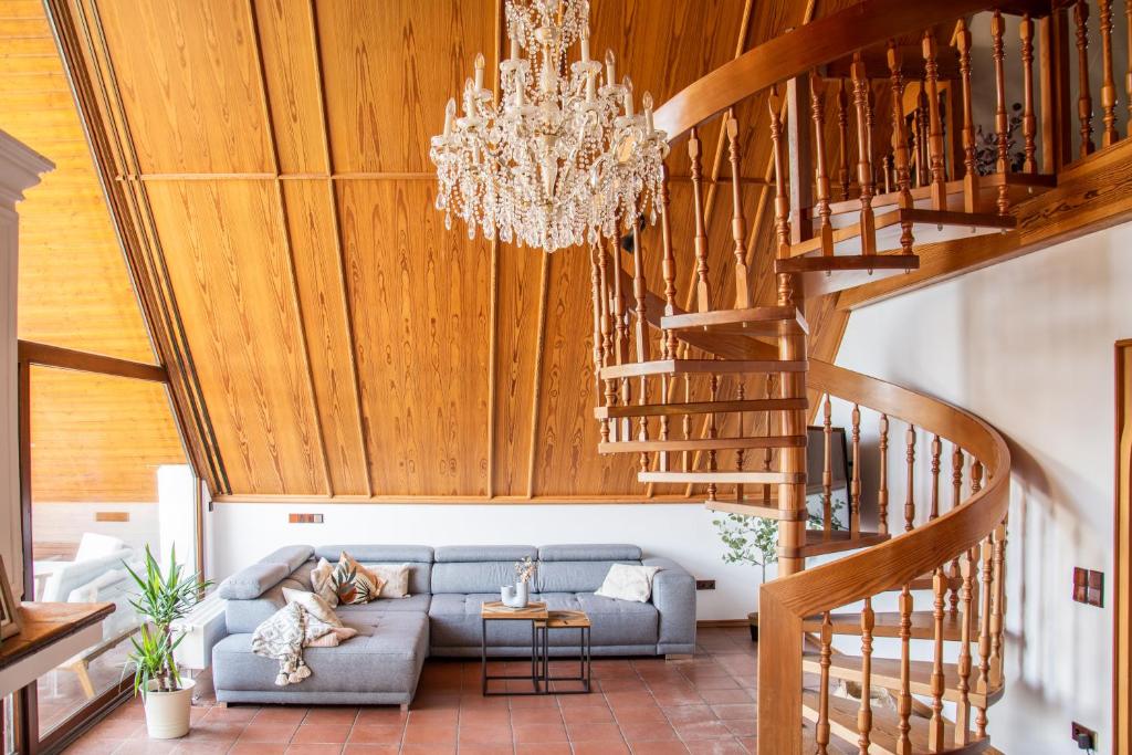 a living room with a couch and a chandelier at Gemütliche Galerie-Wohnung in Biberach in Biberach an der Riß