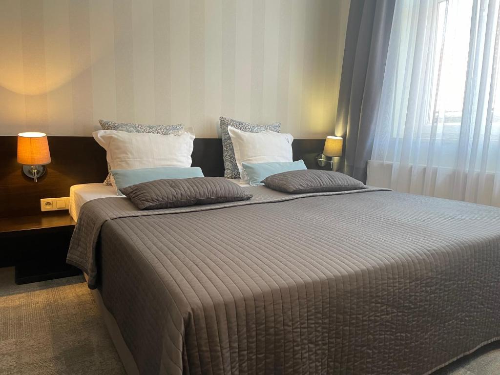 Postel nebo postele na pokoji v ubytování Villa Aronia pokoje z aneksem kuchennym