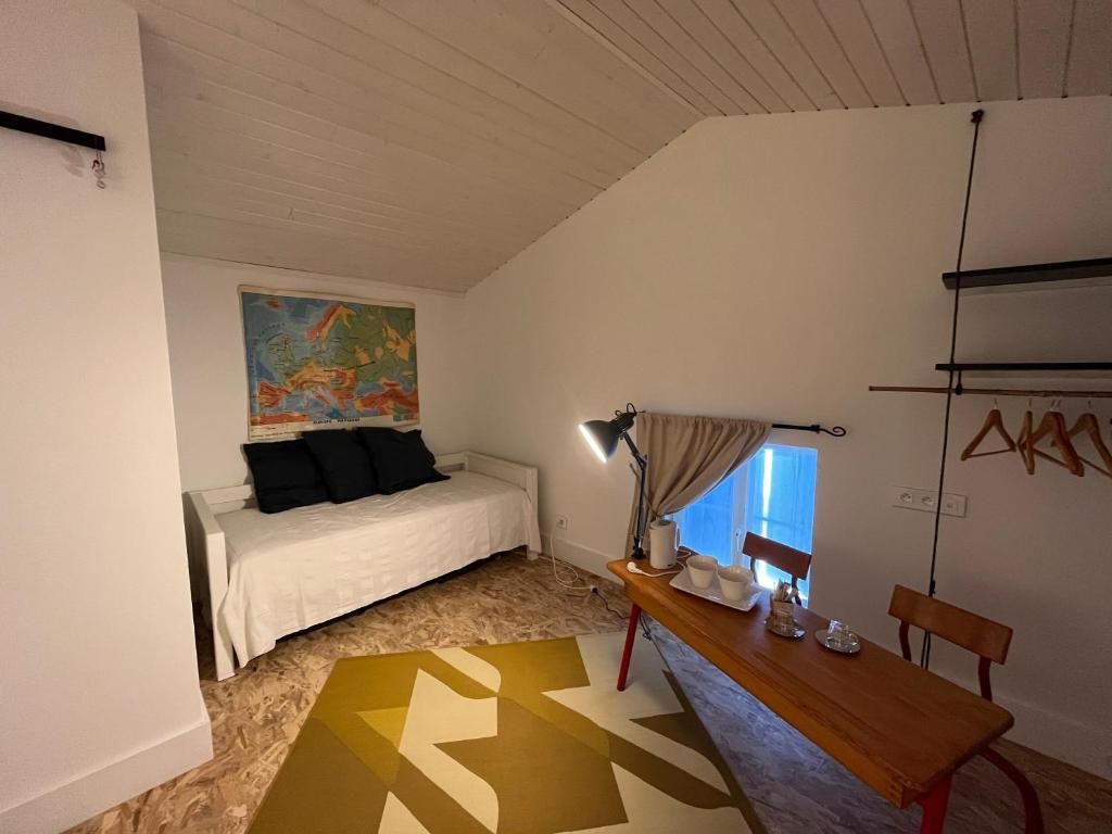 a bedroom with a bed and a desk and a table at LE CLOS DE FLO 17 in Saint-Rogatien