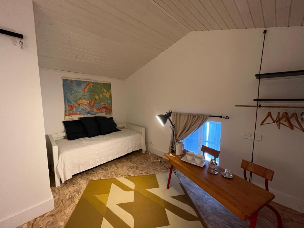 a bedroom with a bed and a desk and a table at LE CLOS DE FLO 17 in Saint-Rogatien