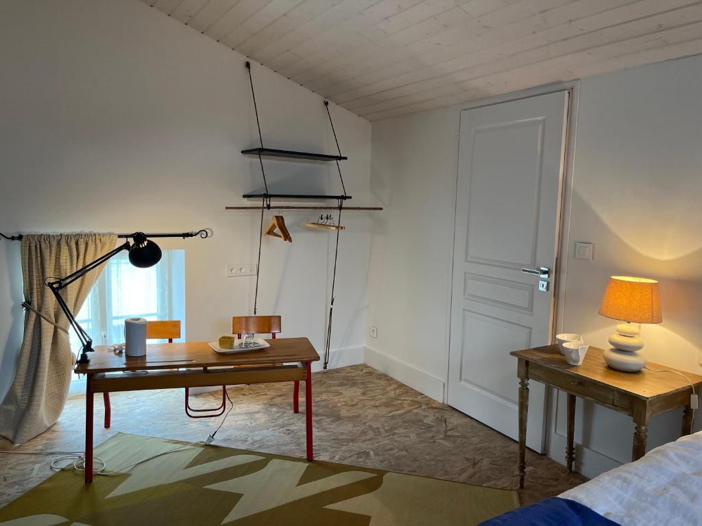 a room with a desk and a lamp and a door at LE CLOS DE FLO 17 in Saint-Rogatien