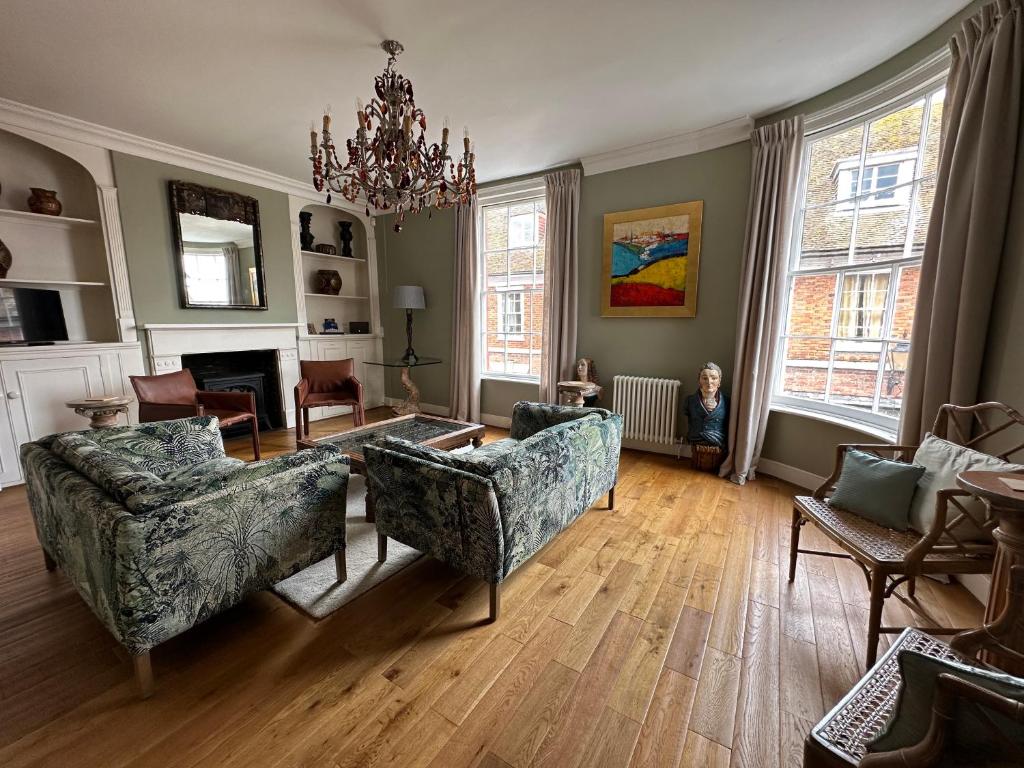 a living room with a chandelier and a couch and chairs at The Brontë Wing at The Apothecary Rye in Rye