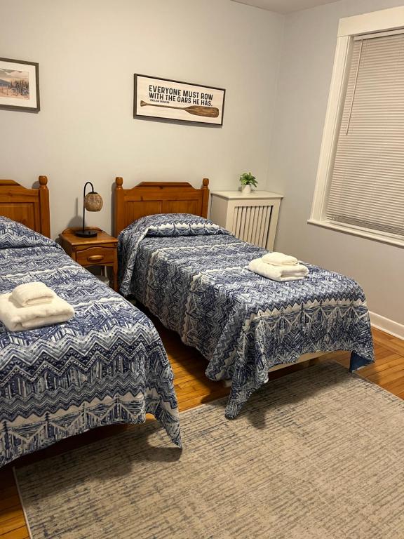 a bedroom with two beds and a rug at Spacious Apartment in Boston in Boston