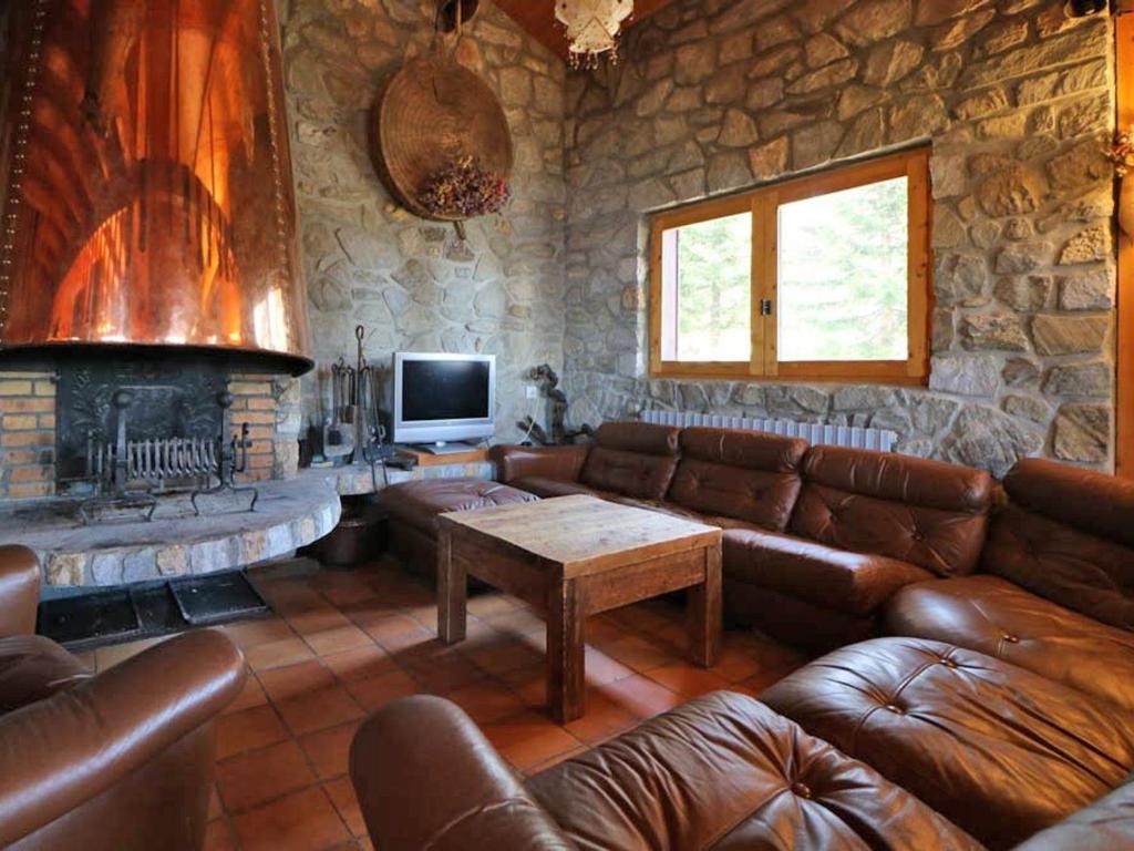 a living room with a couch and a fireplace at Chalet Montvalezan-La Rosière, 9 pièces, 18 personnes - FR-1-398-582 in Montvalezan