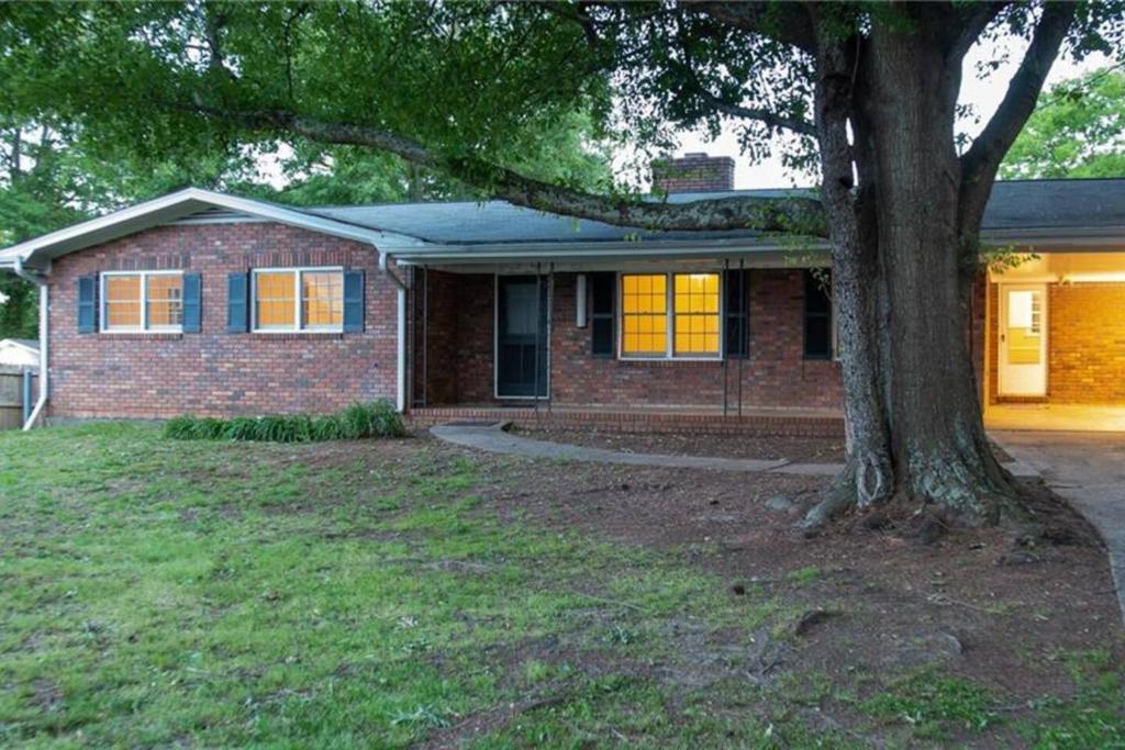 a brick house with a tree in front of it at Home away from home in Marietta