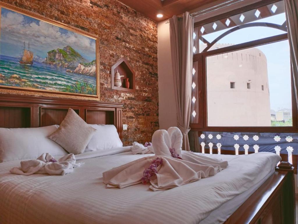 Postel nebo postele na pokoji v ubytování Durrat Nizwa Inn