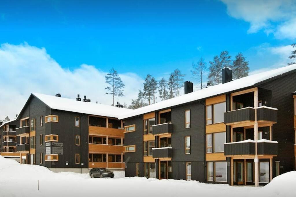 un edificio de apartamentos con nieve en el suelo en Koselig leilighet med et skritt unna skibakken! en Kongsberg
