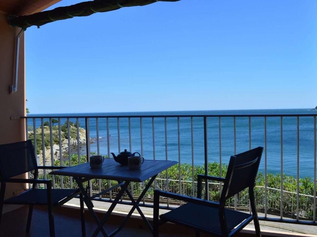 een tafel en stoelen op een balkon met uitzicht op de oceaan bij Appartement Banyuls-sur-Mer, 3 pièces, 6 personnes - FR-1-225C-57 in Banyuls-sur-Mer