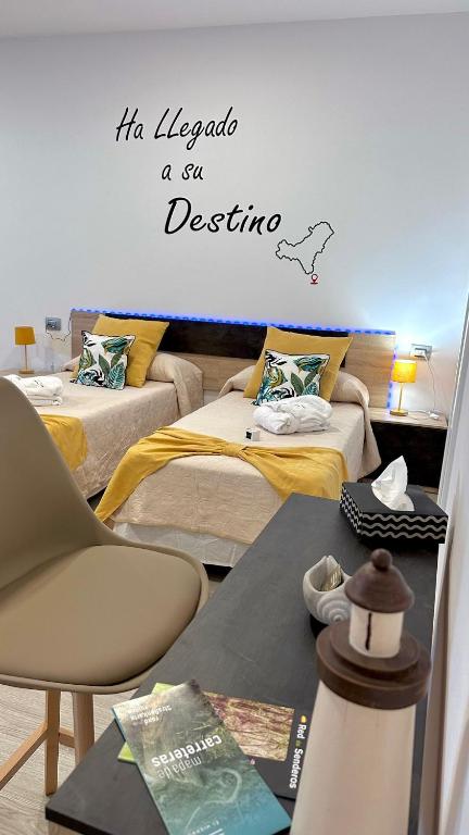 a room with two beds and a table at Luxury La Restinga in La Restinga