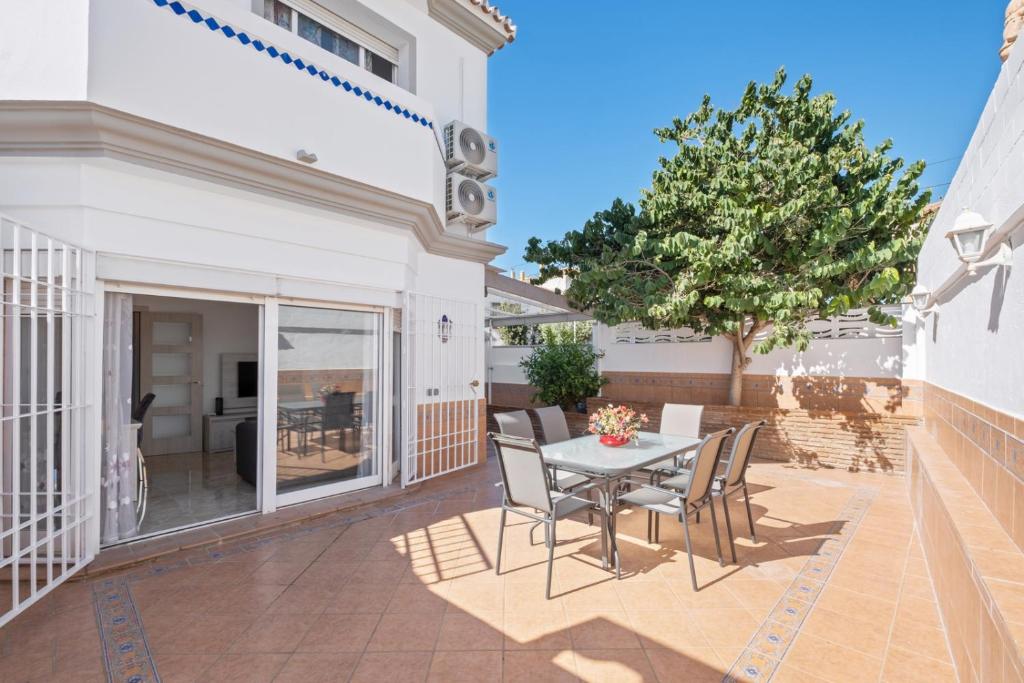 a patio with a table and chairs on it at Villa Montelimar - Biznaga Rental Homes in Rincón de la Victoria