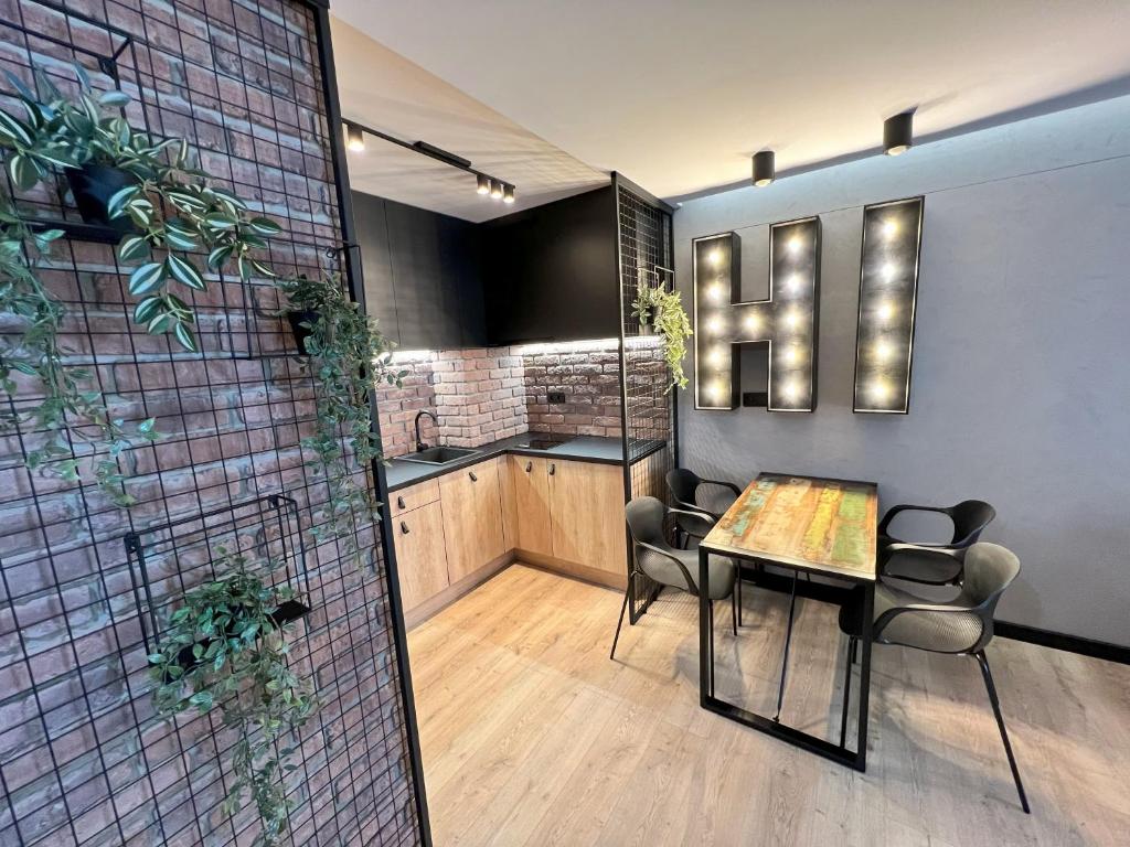 a dining room with a table and some chairs at Hi Apartments Kozia in Kielce