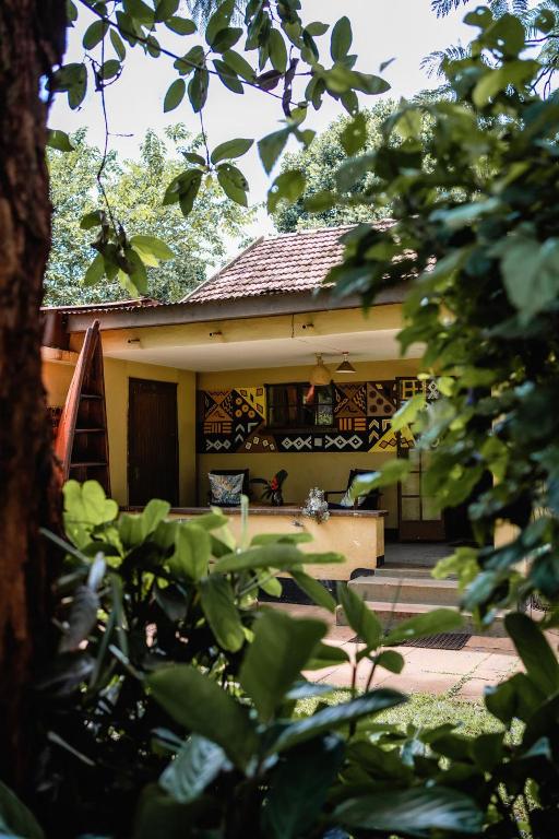 a house with a porch in the background at 30 Wilson in Jinja