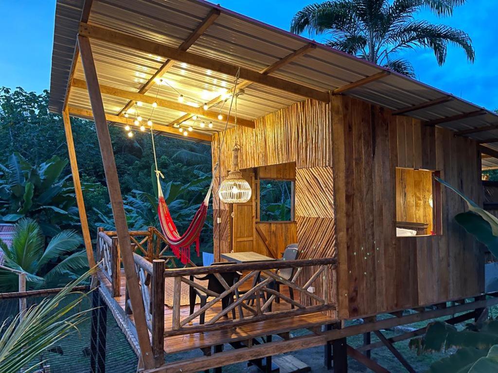 a small wooden house with a hammock in it at TORTUGA BAY Eco Hotel in El Valle