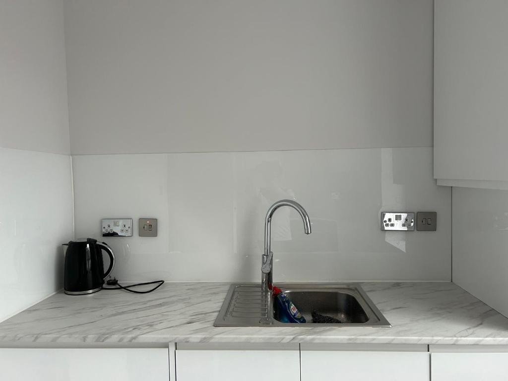 a kitchen sink with a faucet on a counter at Victoria in London