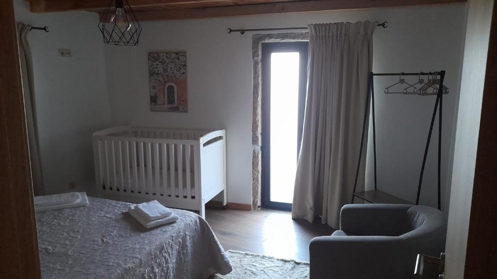 Uma cama ou camas num quarto em Casa Tia Vina - Serra