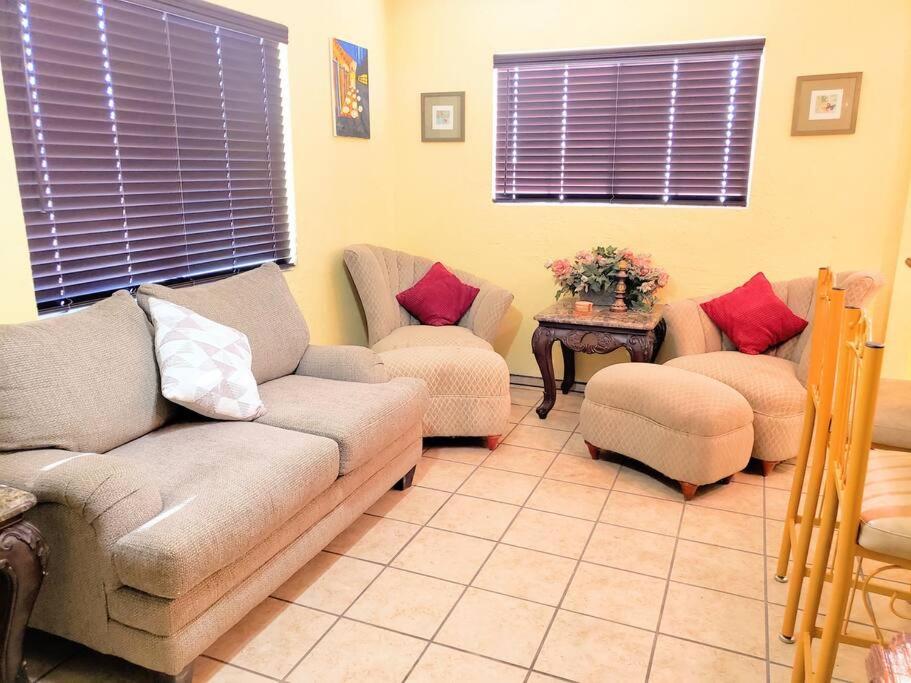 a living room with couches and chairs and a table at White Sands Casita in Alamogordo