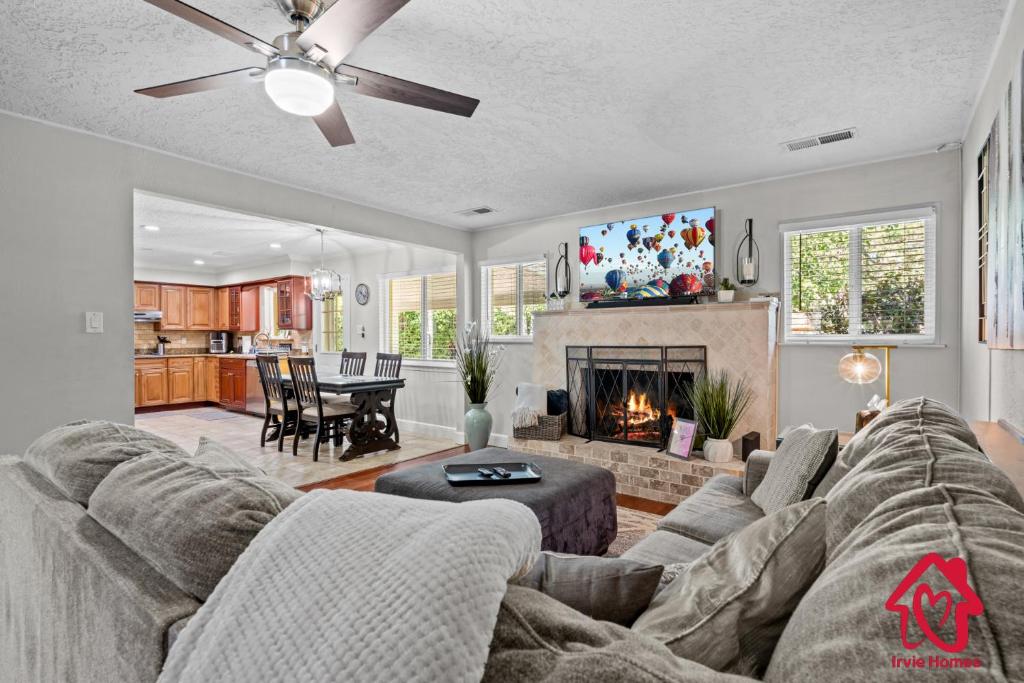 a living room with a couch and a fireplace at San Gabriel Stunner - An Irvie Home in Albuquerque