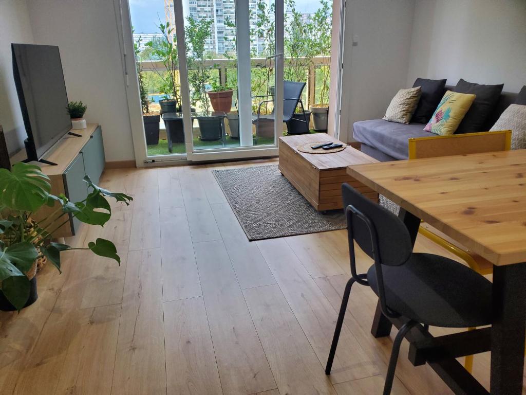 een woonkamer met een tafel en een bank bij Sweet Home in Mulhouse