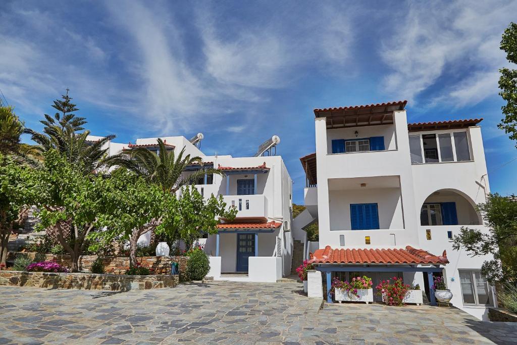 a large white building with a shop in front of it at Irene Studios in Agios Petros