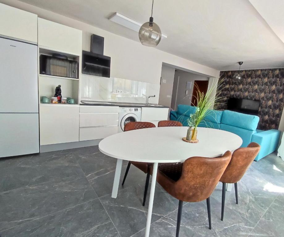 una cucina e un soggiorno con tavolo e sedie bianchi di Apartamento Suite 48- Recién reformado ad Avilés