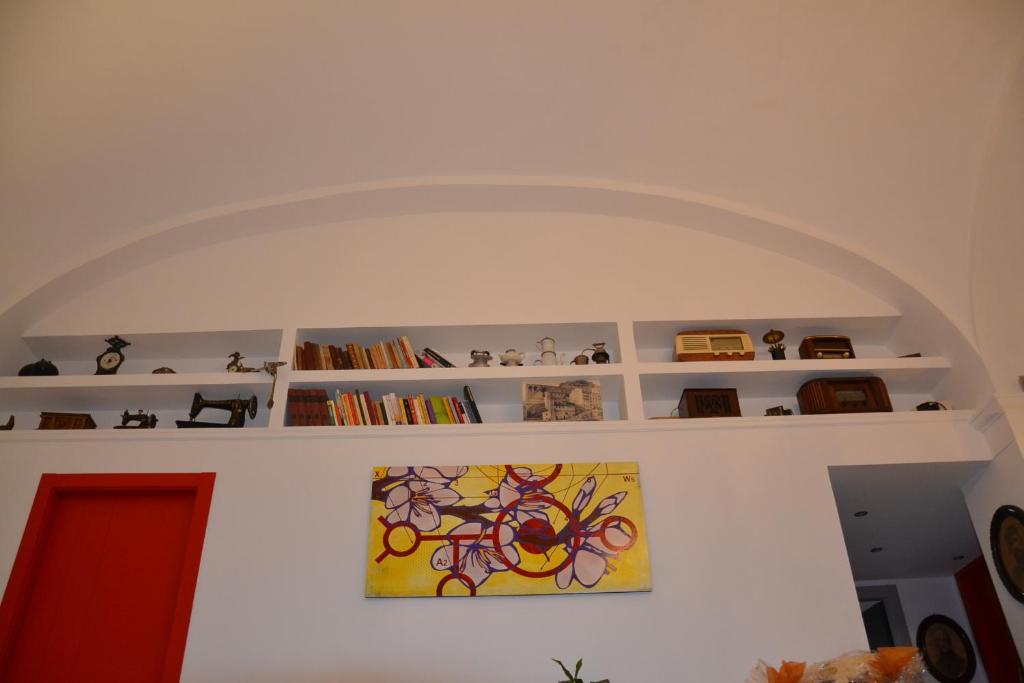 a room with a painting on a wall with shelves at B&B Torre Porta Marina in Ventimiglia