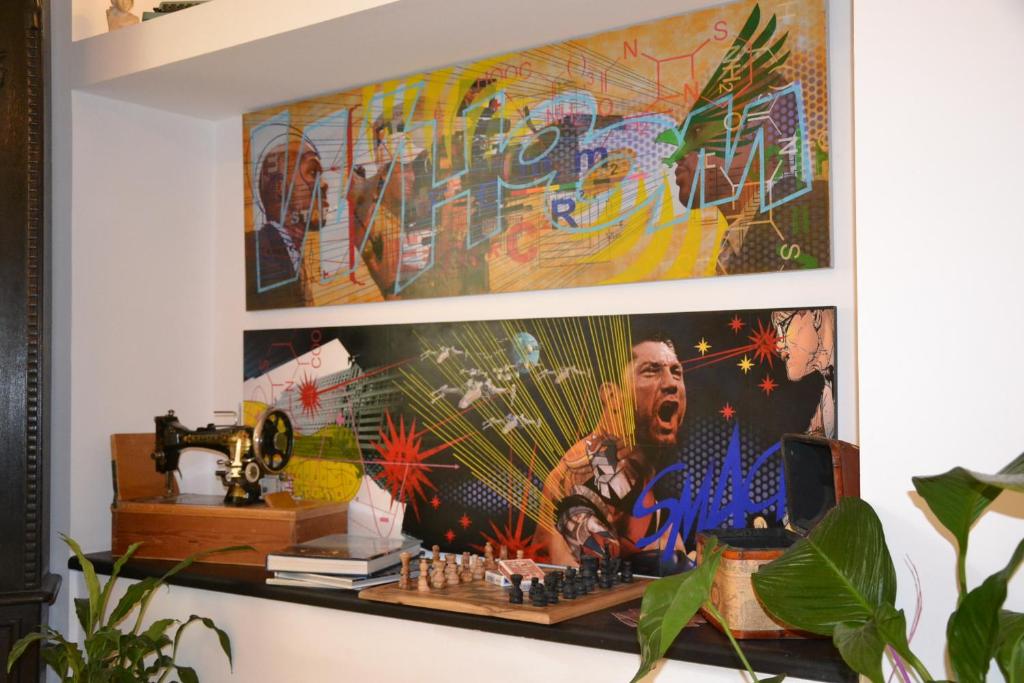 a wall with a picture of a man playing chess at B&B Torre Porta Marina in Ventimiglia