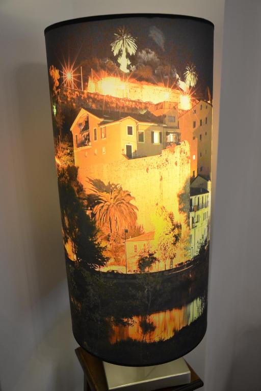 a vase with a painting of a city on it at B&B Torre Porta Marina in Ventimiglia