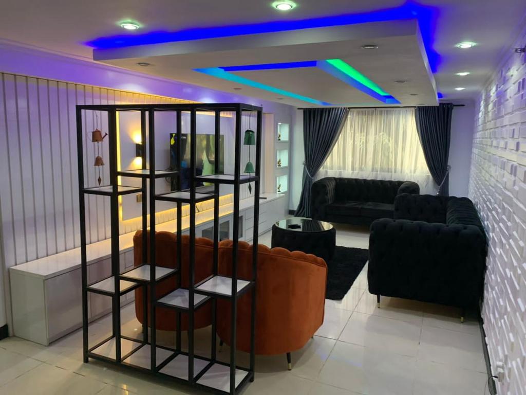 a living room with a couch and a table at Luxurious B in Lagos