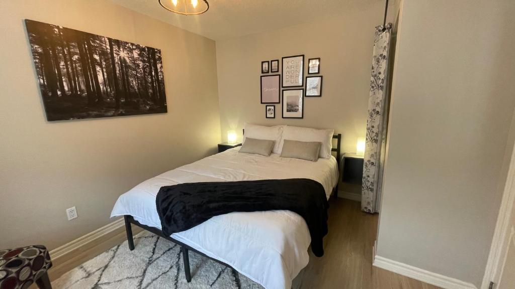 a bedroom with a bed with a black blanket on it at Market Place Living in Stratford