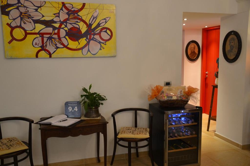 a room with a table and chairs and a painting at B&B Torre Porta Marina in Ventimiglia