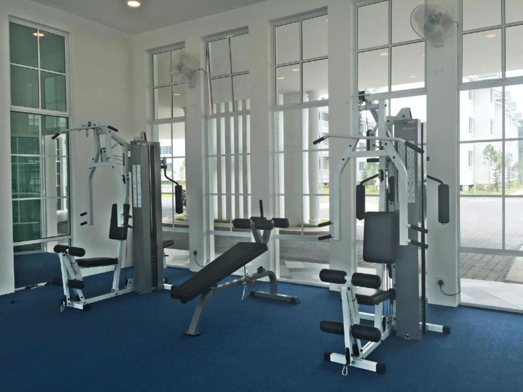 a gym with two tread machines in a room with windows at The Trails of Kampar in Kampar