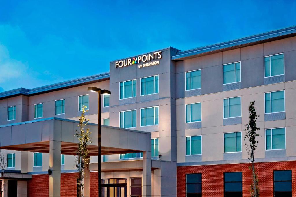 a building with a sign on the side of it at Four Points by Sheraton Edmonton International Airport in Nisku