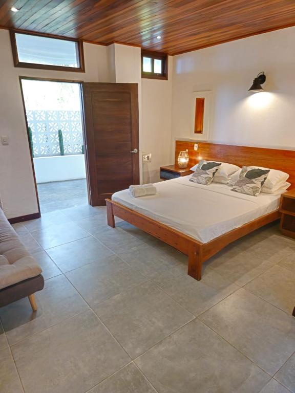a bedroom with a large bed in a room at Makao Beach Hotel in Palomino
