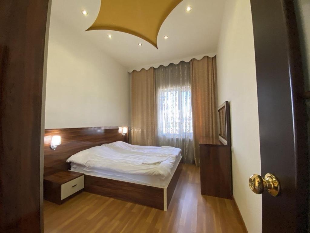 a bedroom with a bed and a large window at Large 5 bedroom VIP Villa 2 in Yerevan