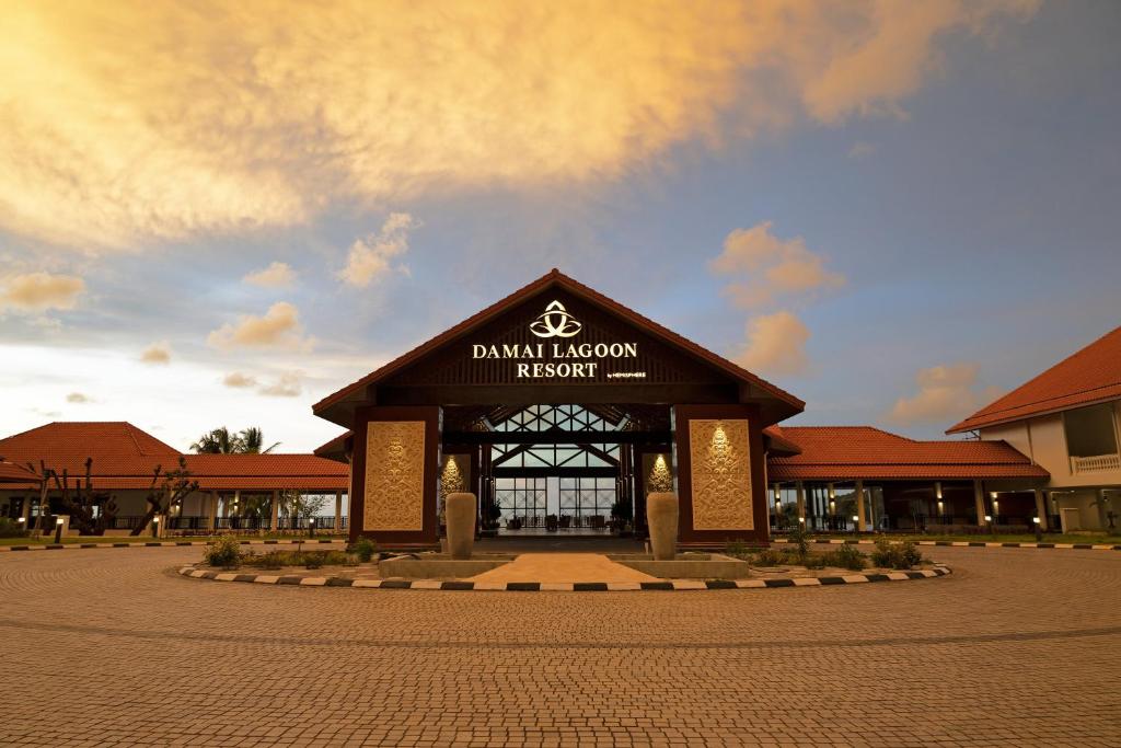 a building with a sign on the front of it at Damai Lagoon Resort in Santubong