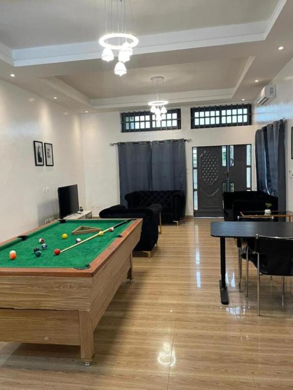 a living room with a pool table in it at AGIM-GUESTHOUSSE in Abomey-Calavi