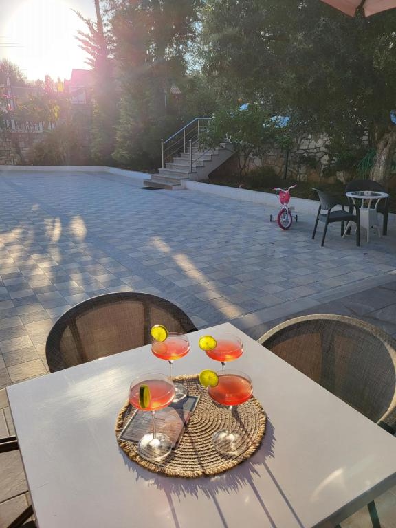 a white table with some glasses on top of it at Augustus Hotel in Dhërmi