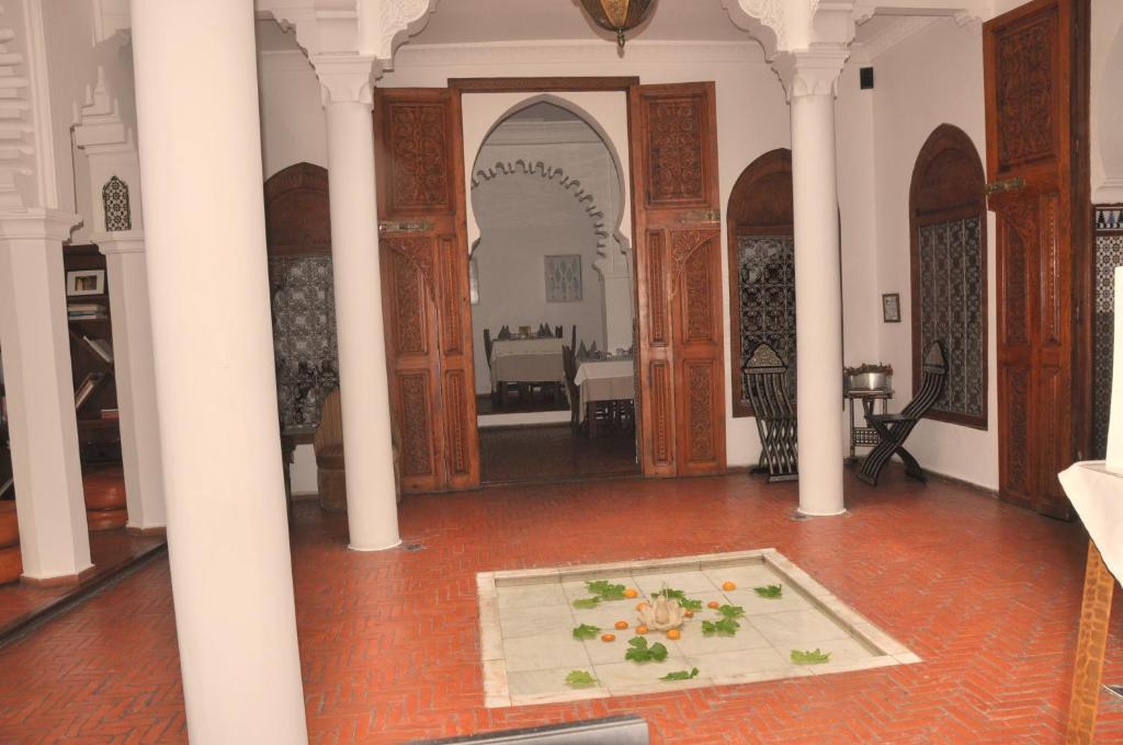 a large room with a table in the middle at Hotel Blanco Riad in Tetouan