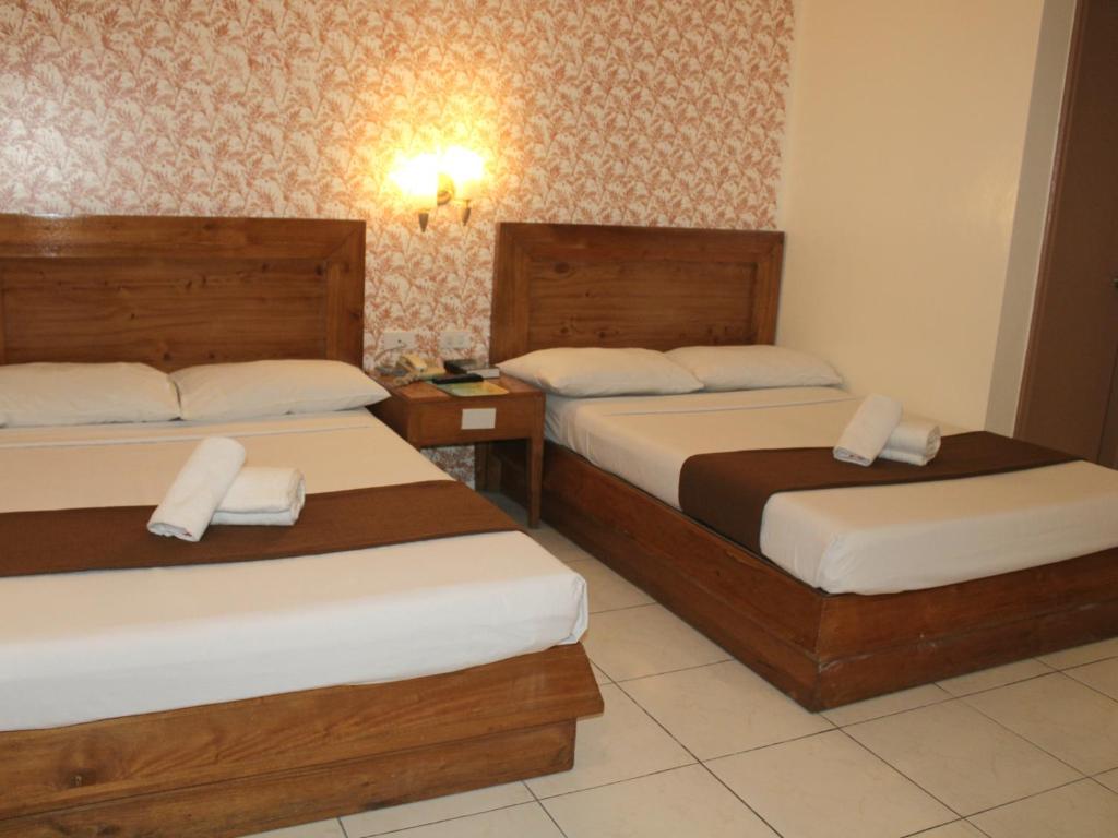 Postel nebo postele na pokoji v ubytování Rosas Garden Hotel