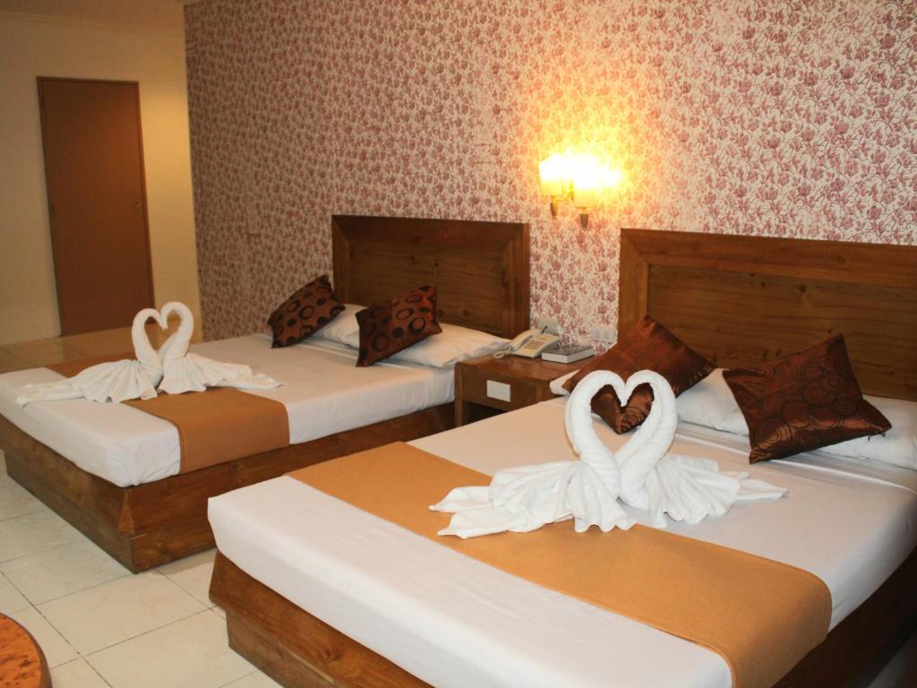 Postel nebo postele na pokoji v ubytování Rosas Garden Hotel